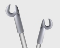 Two metallic wrenches angled towards each other against a plain background.