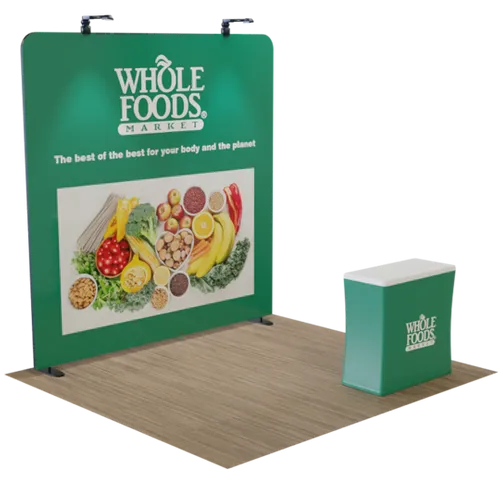 A trade show display features Whole Foods Market branding with text 'The best of the best for your body and the planet' and a counter with the company logo.