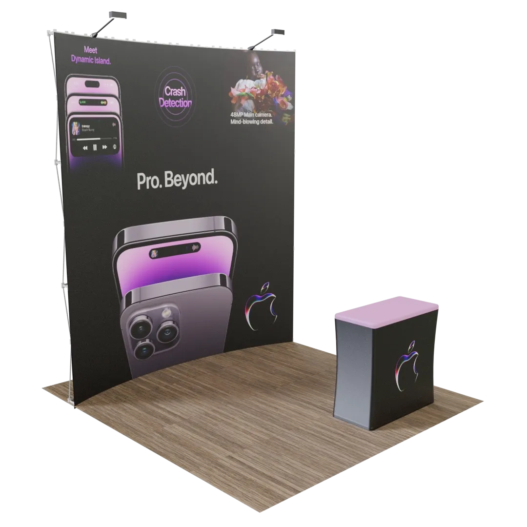 This is a trade show display featuring a large back wall and a promotional counter with graphics of a smartphone, advertising features like 'Dynamic Island' and 'Crash Detection.' Text: 'Pro. Beyond.'